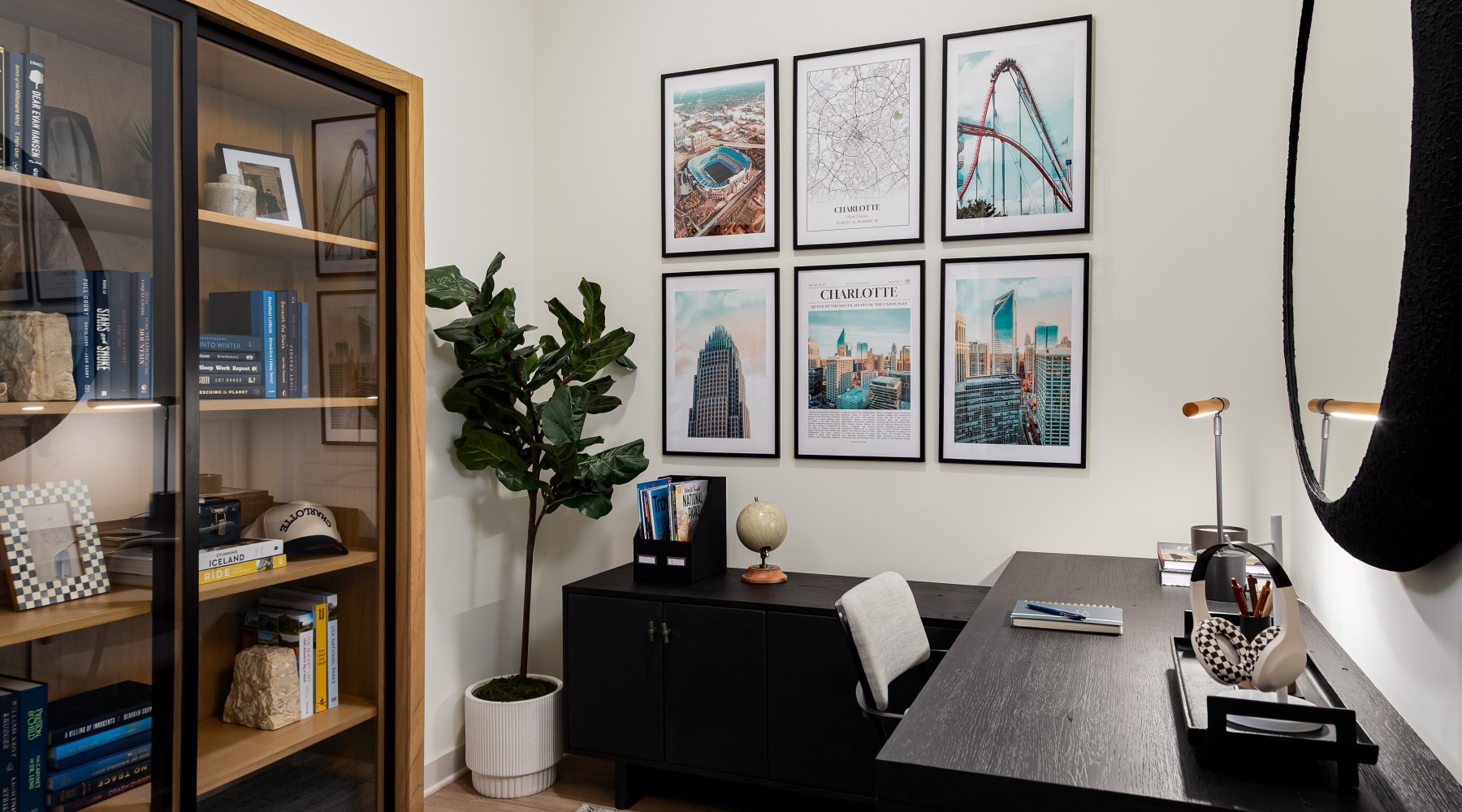 room with large L-shaped desk and large bookcase