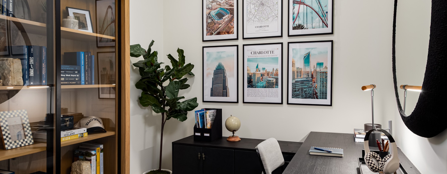 room with large L-shaped desk and large bookcase