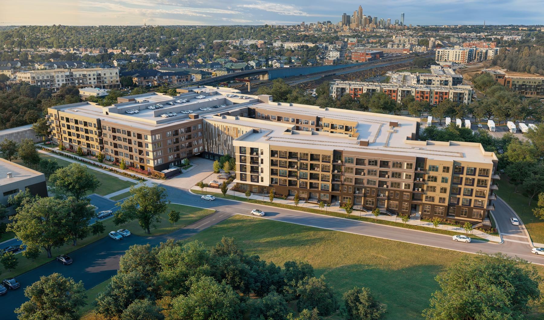 a large building with a parking lot and lush landscaping